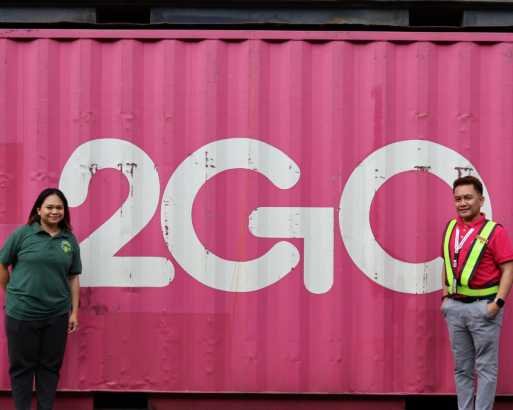 2GO staff standing beside a pink 2GO shipping container