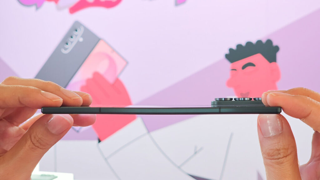 Samsung Galaxy Z Fold8 held sideways between two fingers to show how thin it is when folded