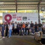 AIA Hope Mobi Clinic team and volunteers posing in front of the mobile clinic