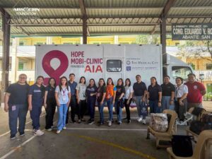AIA Hope Mobi Clinic team and volunteers posing in front of the mobile clinic